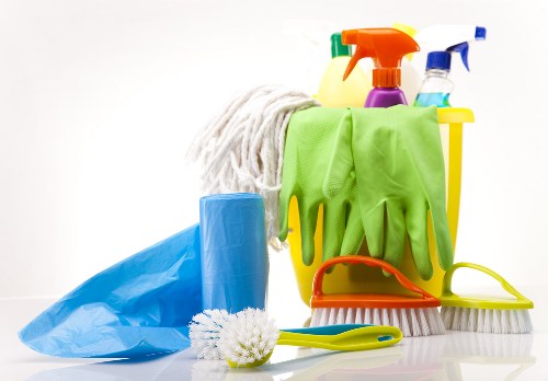 Cleaner working carefully in a protected indoor environment