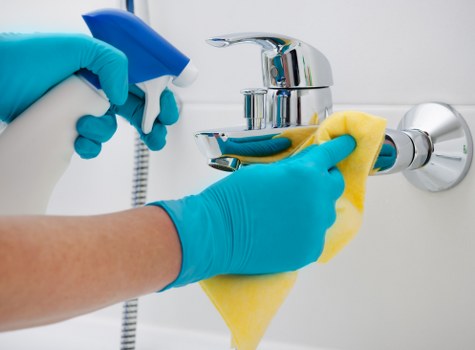 Cleaner responding to an incident with safety precautions