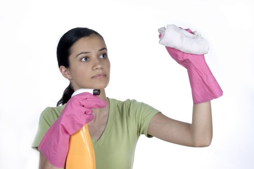 Local office cleaning team disinfecting desks and touchpoints
